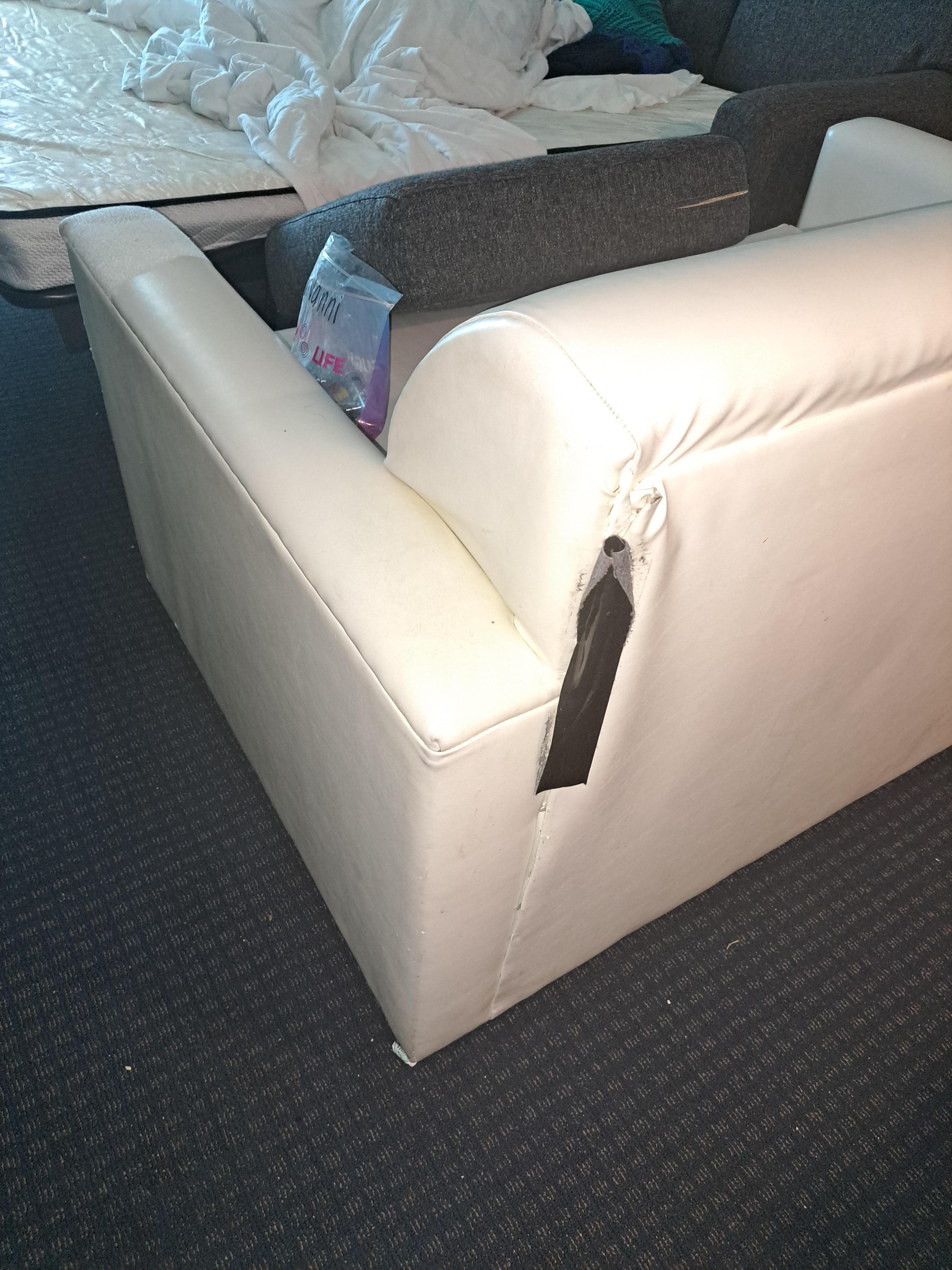 Torn couch with duct tape
