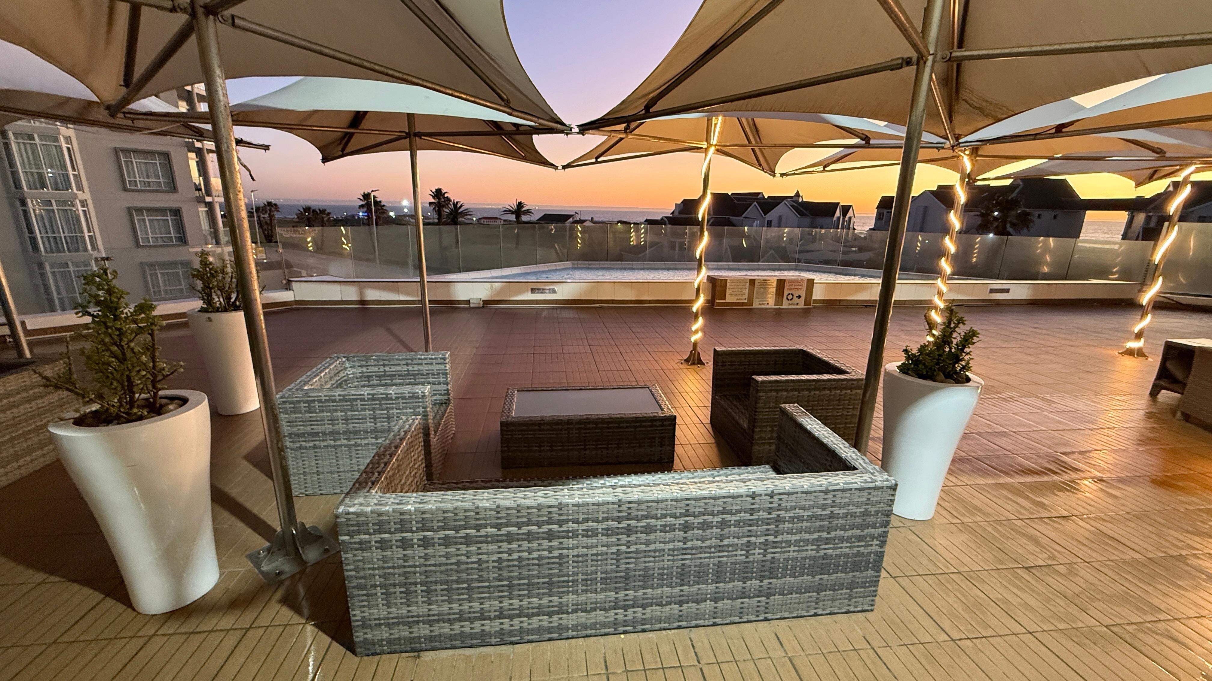 Sunrise view of ocean across pool deck view 2