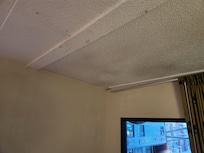 Ceiling water damage by window