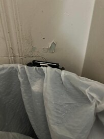 Paint chipping behind the trash can