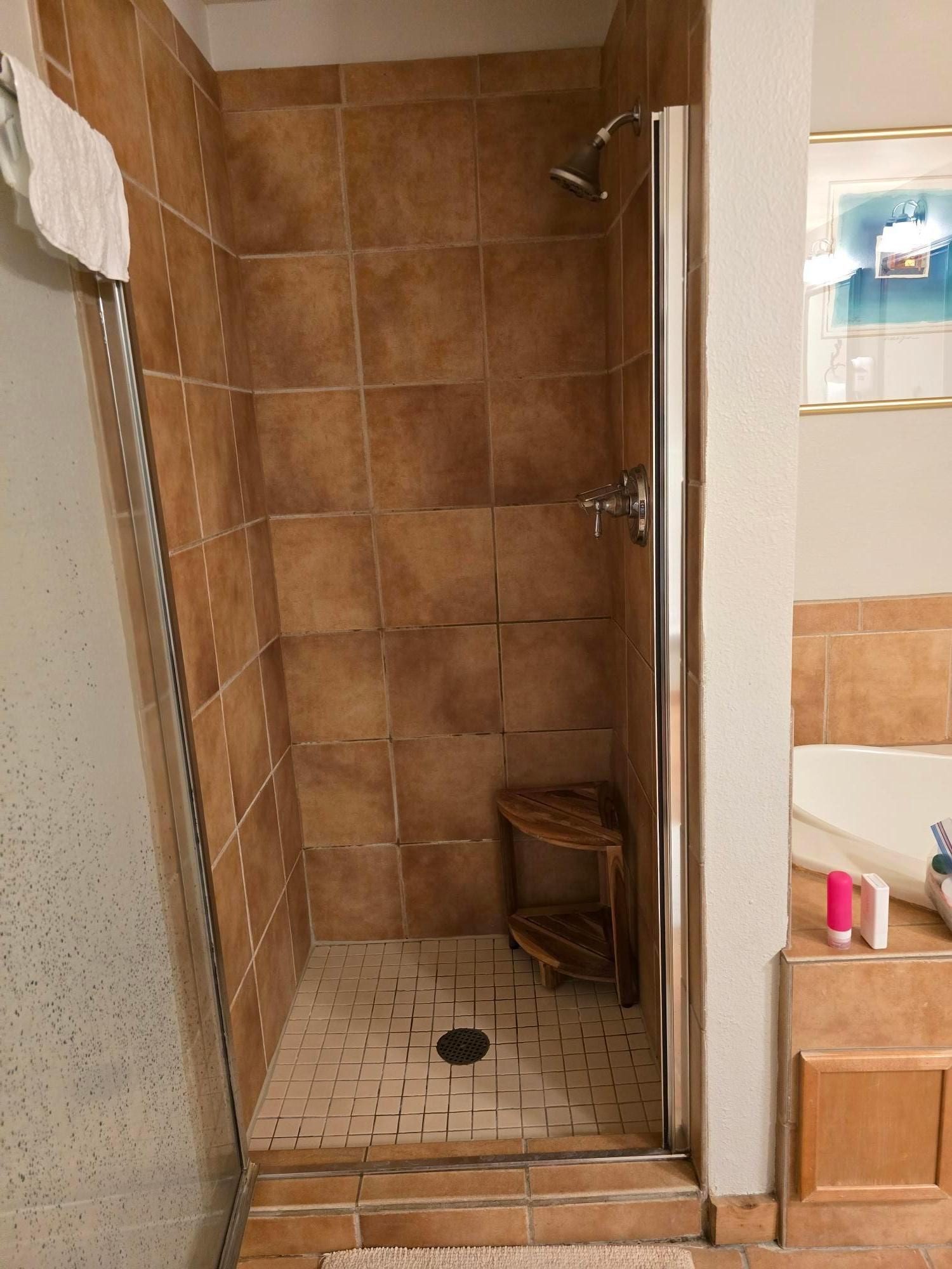 The master shower is very small and cramped, it is uncomfortable to use, and the shower door feels cheap and low quality.