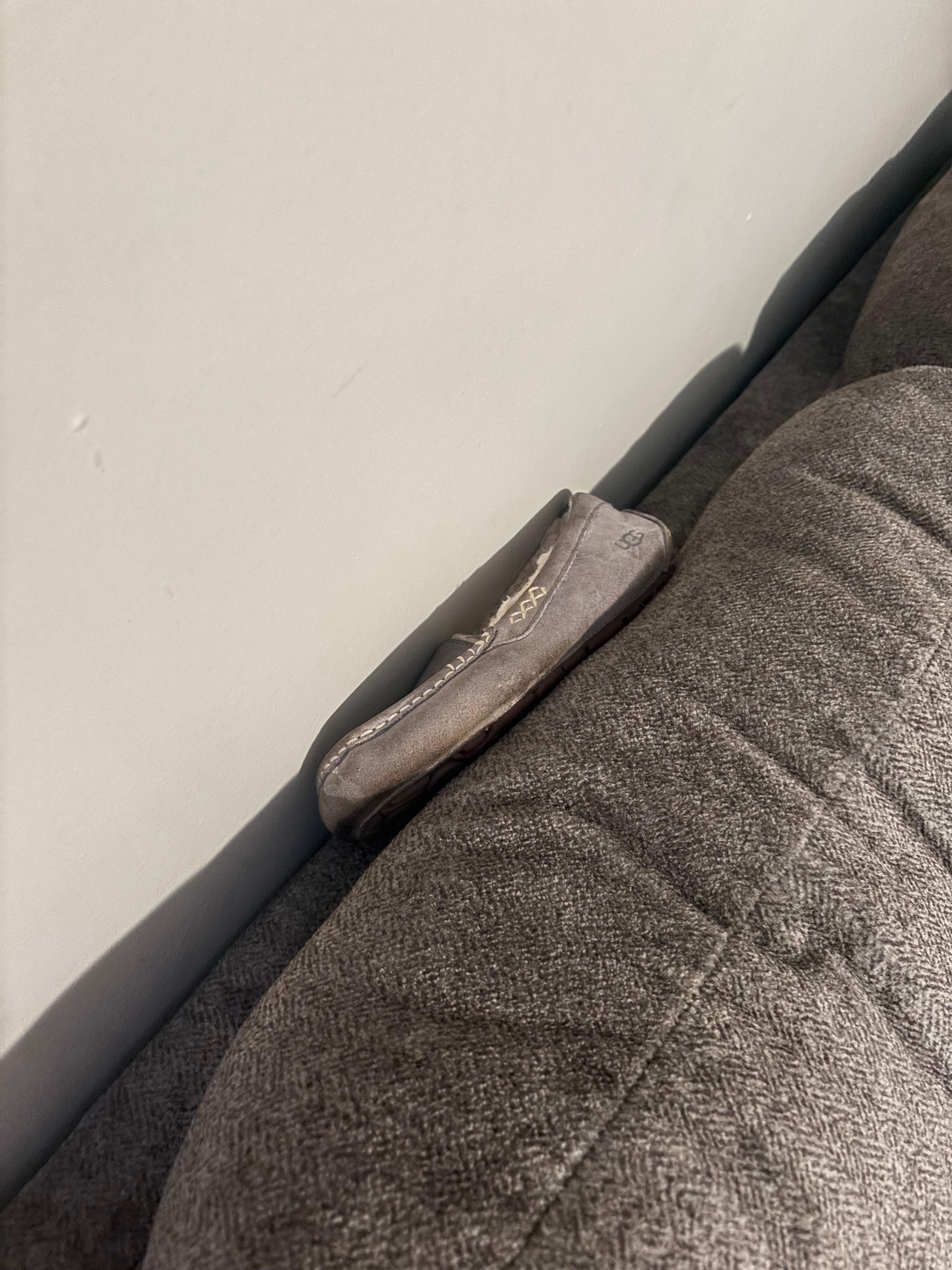 Found a shoe resting on the back of the couch. Is a cleaning person really coming to clean this property? I doubt it. 