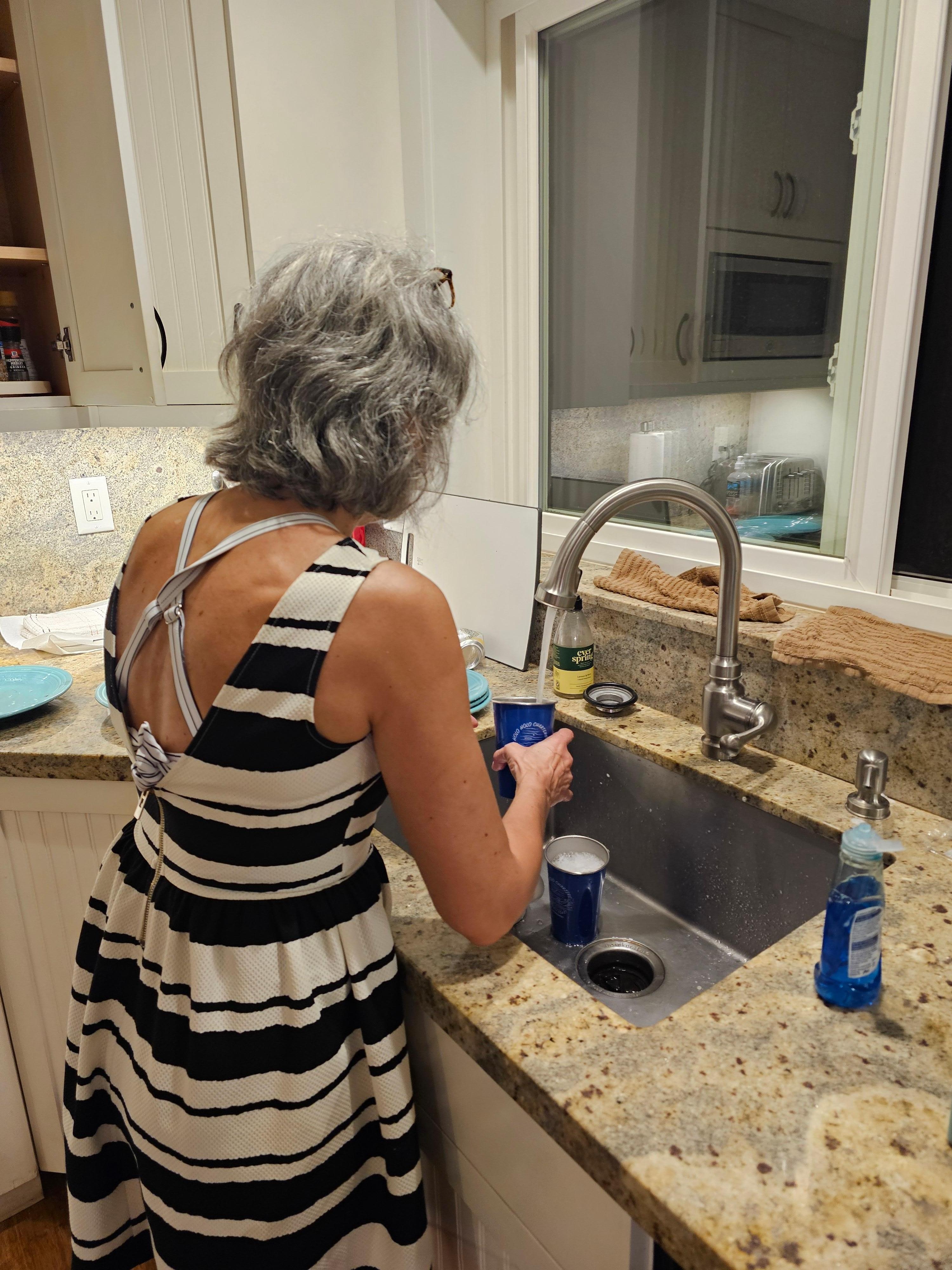 My wife doing dishes by hand on her vacation. 