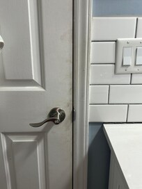 Dirty handprints on bathroom door