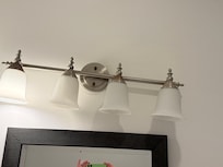 Only 1 light bulb i. working conditions in the restroom.
