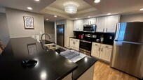 Large kitchen and counter with two refrigerators.