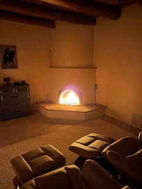 Kiva in primary bedroom in front of messaging chairs.