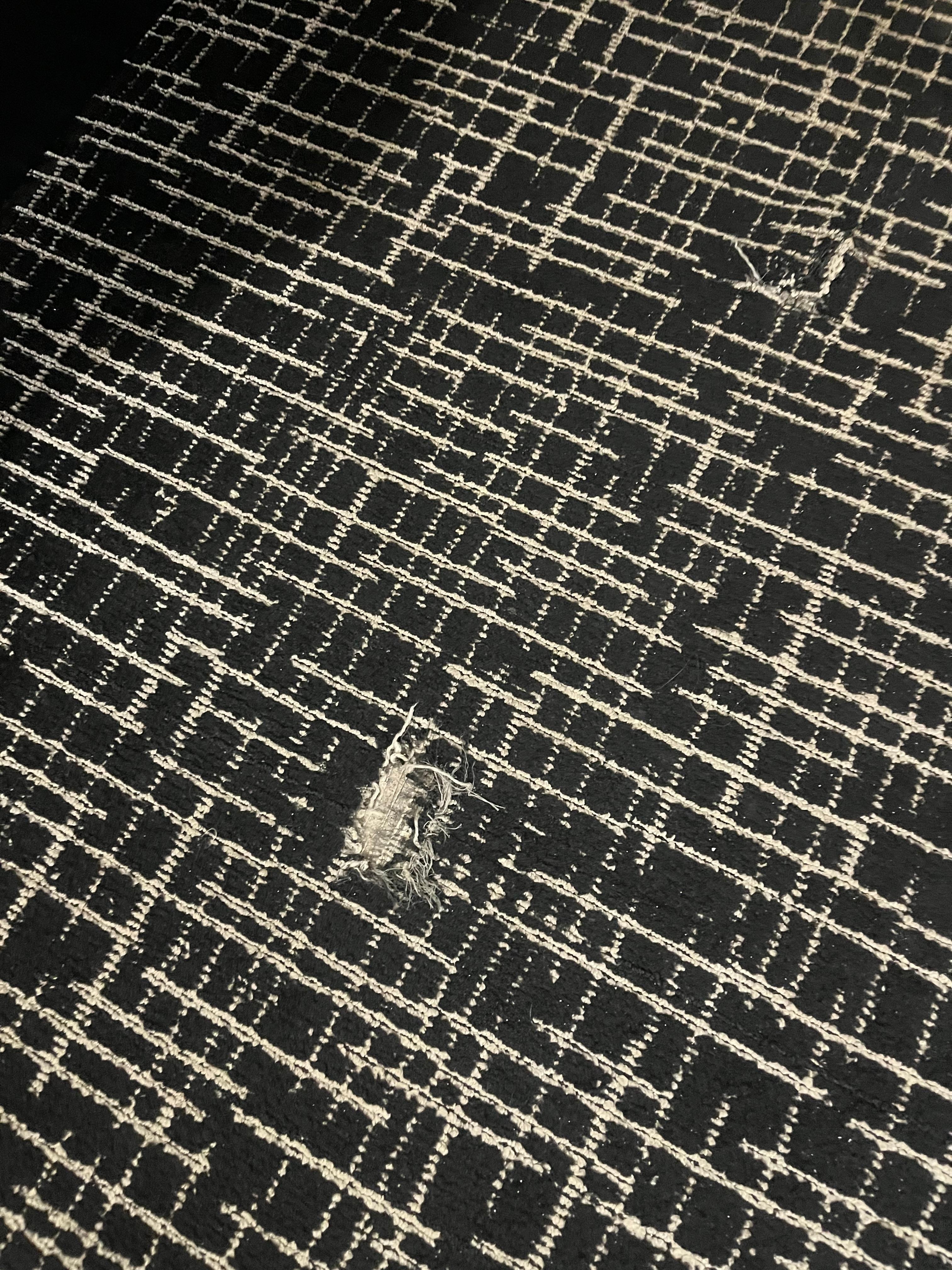 Tear in the floor and no light bulbs in the bedside lamps 