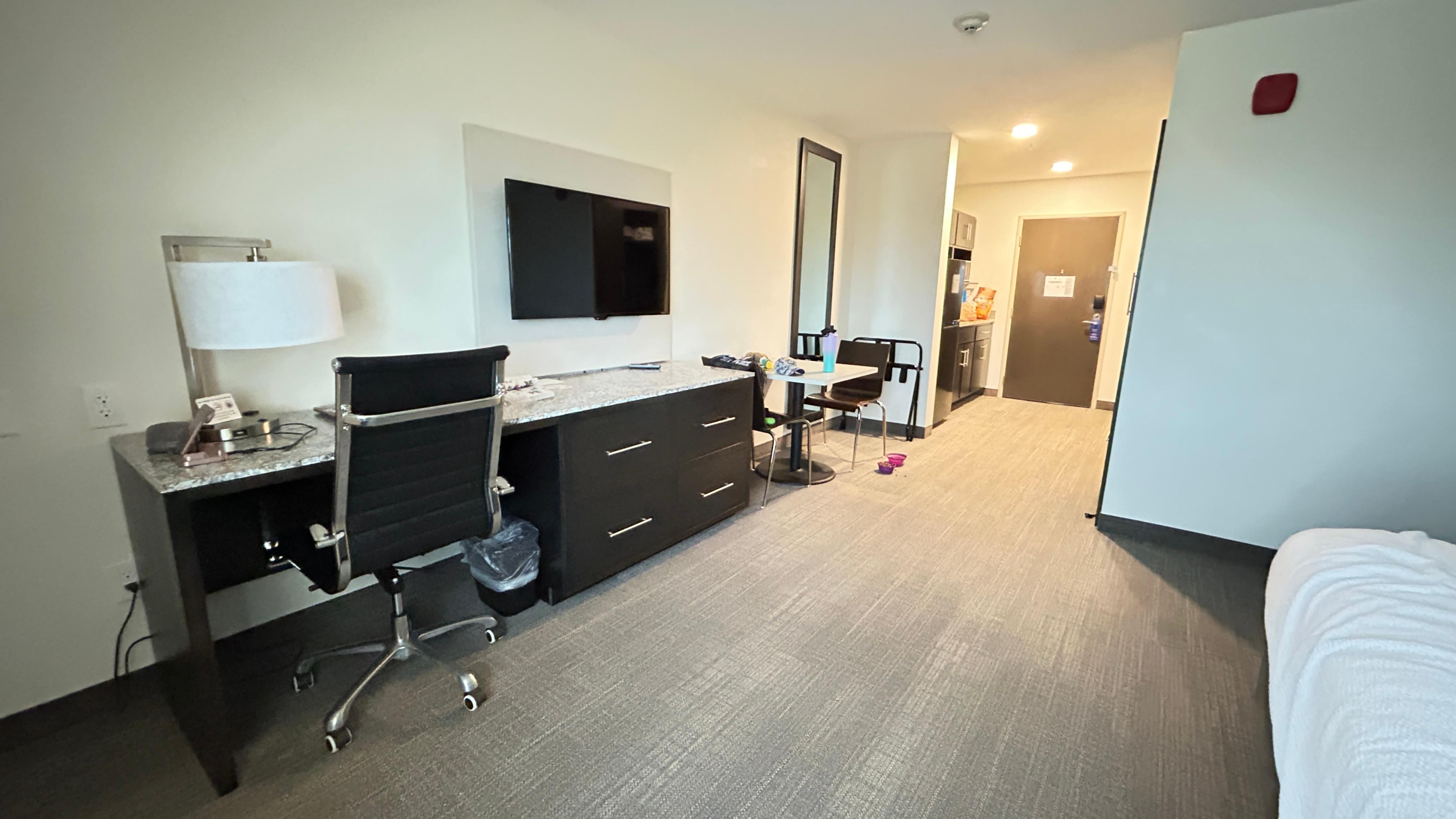 Nice desk area, dresser, and cute table to eat at.