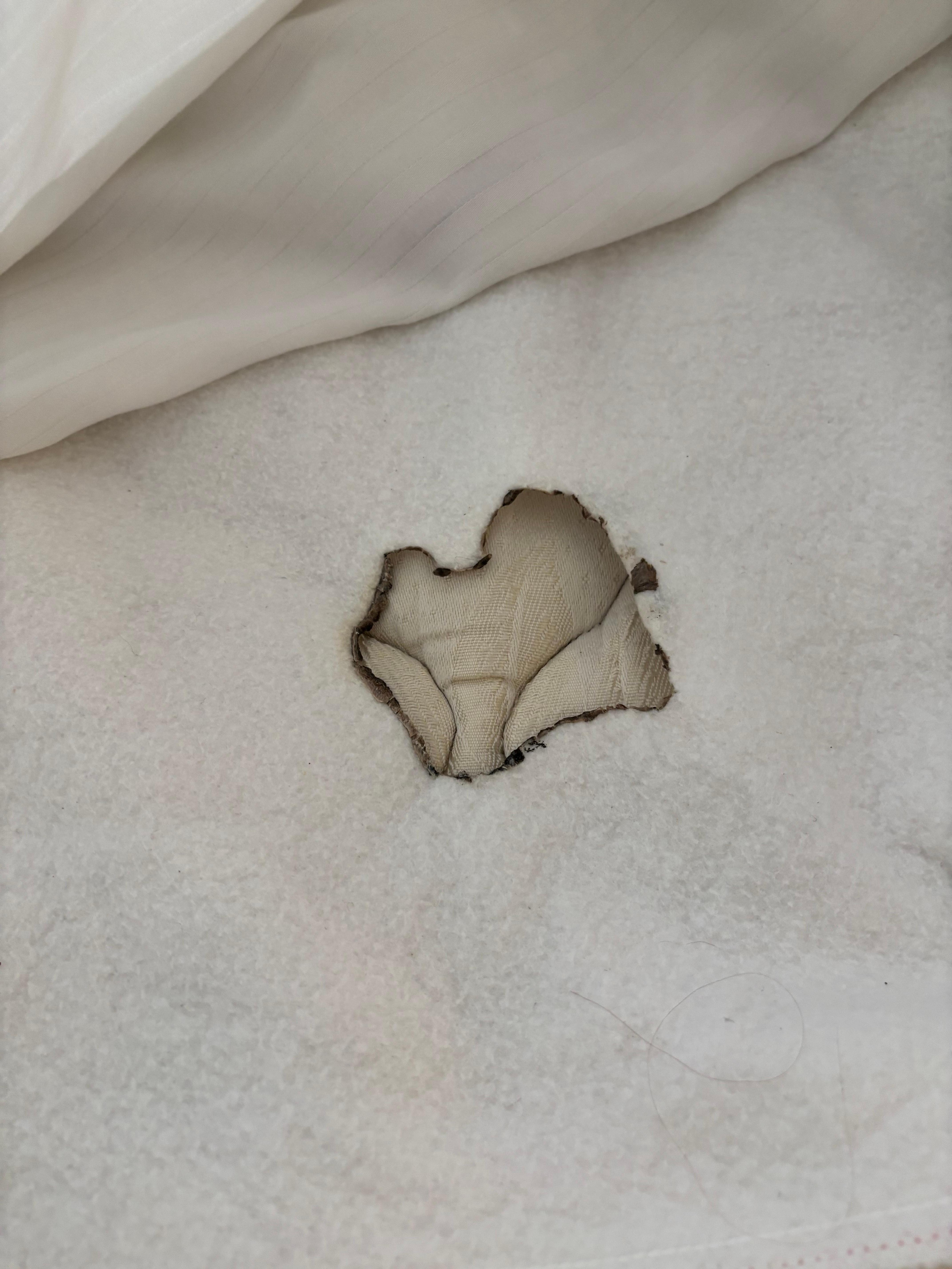 mattress protector with a burnt hole