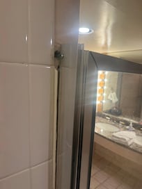 Shower door barely hanging on