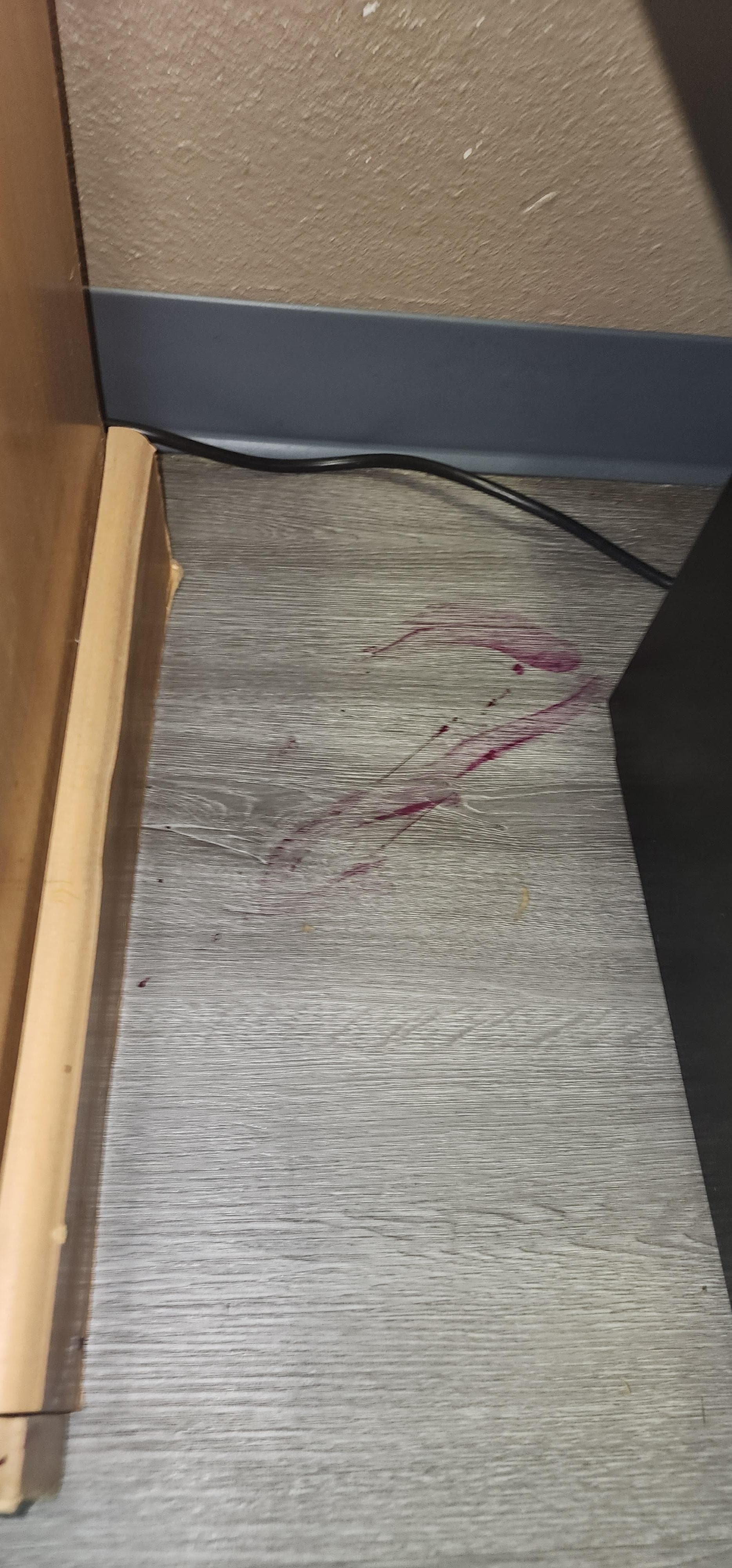 Right by the bed....the trail of red stains started in the middle of the room and led to this location.