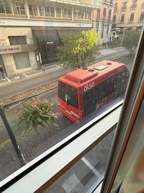 Bus right below the room with wall to ceiling windows