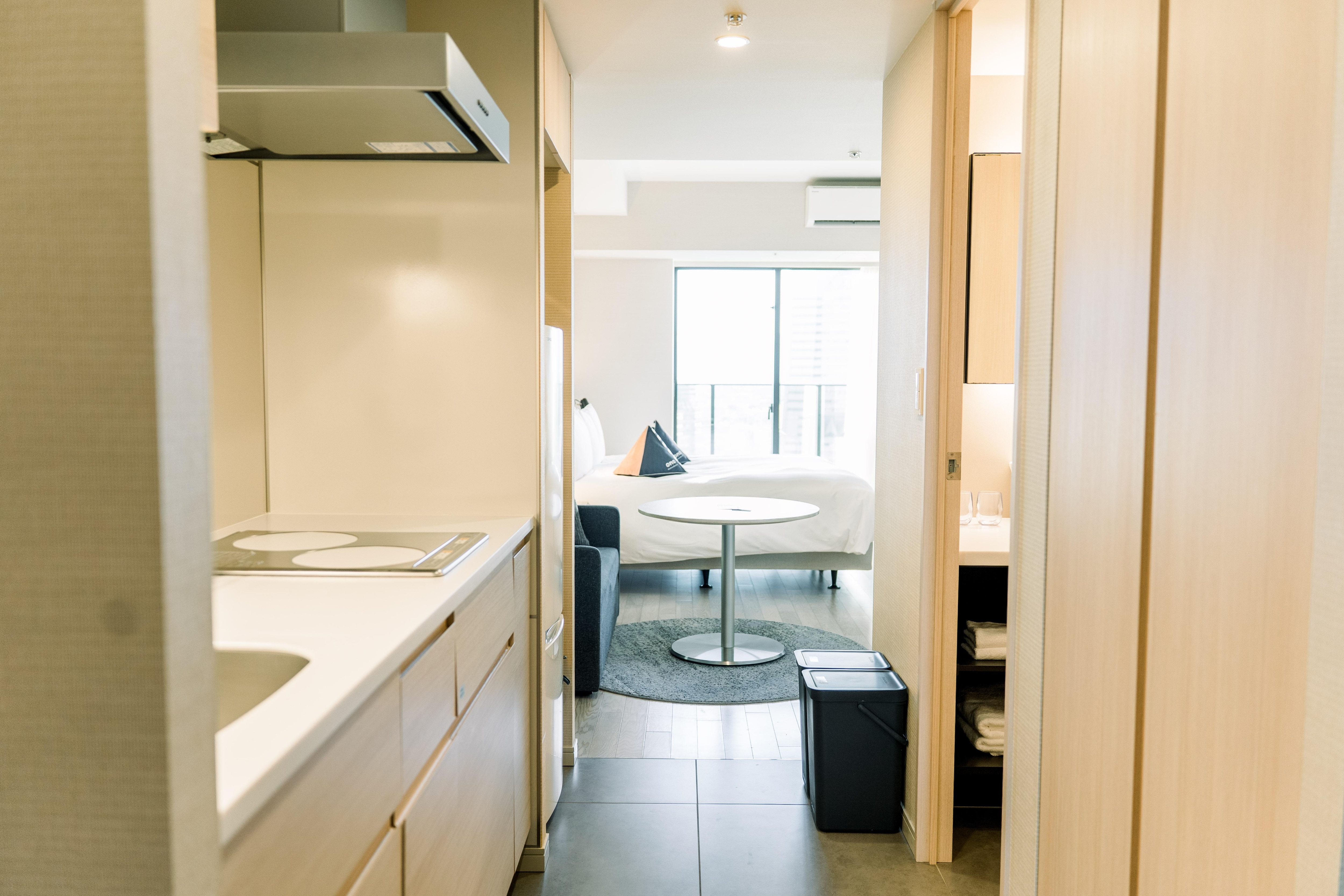 Hotel room. The laundry machine is both a washer and dryer in one. It is located inside the closet on the right beside the washroom.
