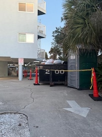 Facing building from road / one side of driveway, including our parking spot completely blocked.