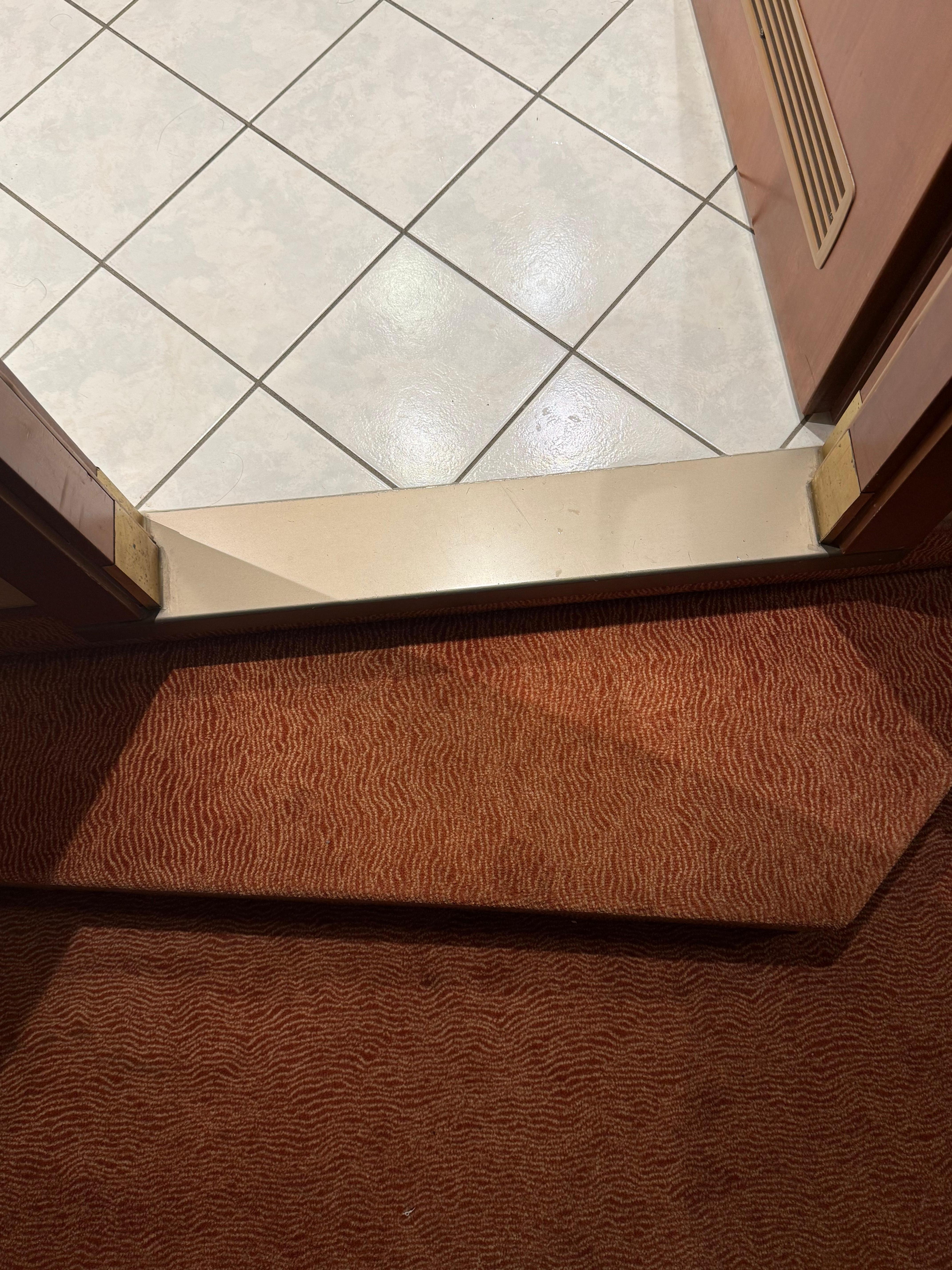 This is an eight inch drop to ground level which is not expected when existing the bathroom.