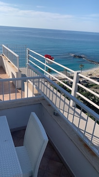 Patio with table and 4 chairs by front door of our room 309