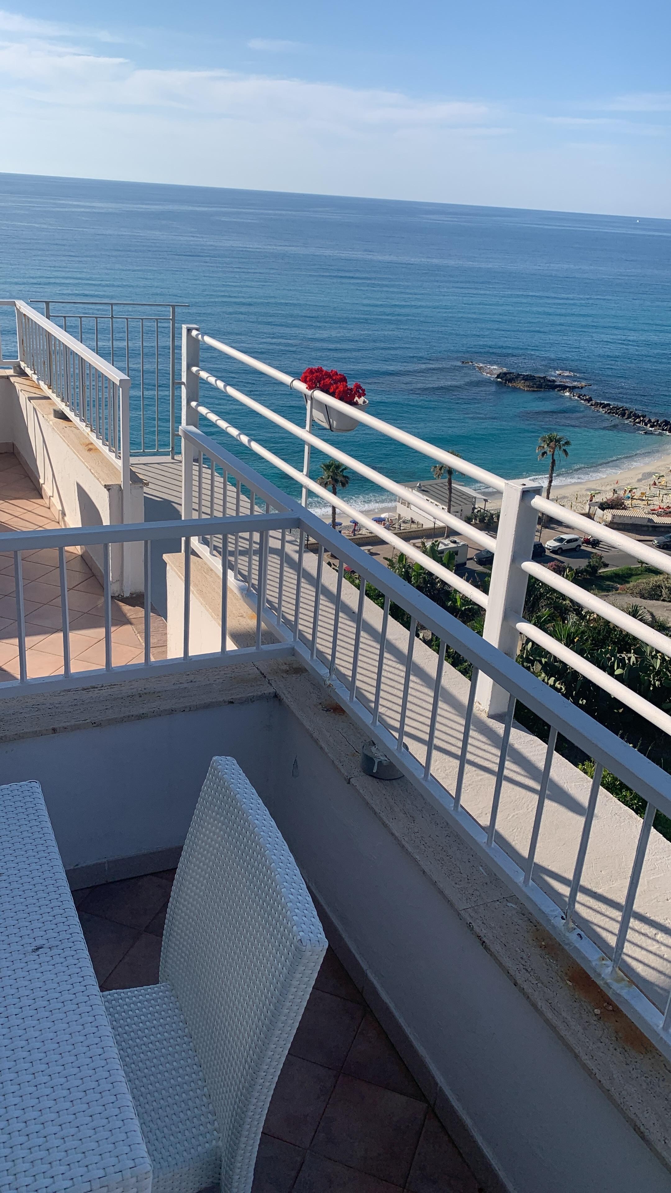 Patio with table and 4 chairs by front door of our room 309