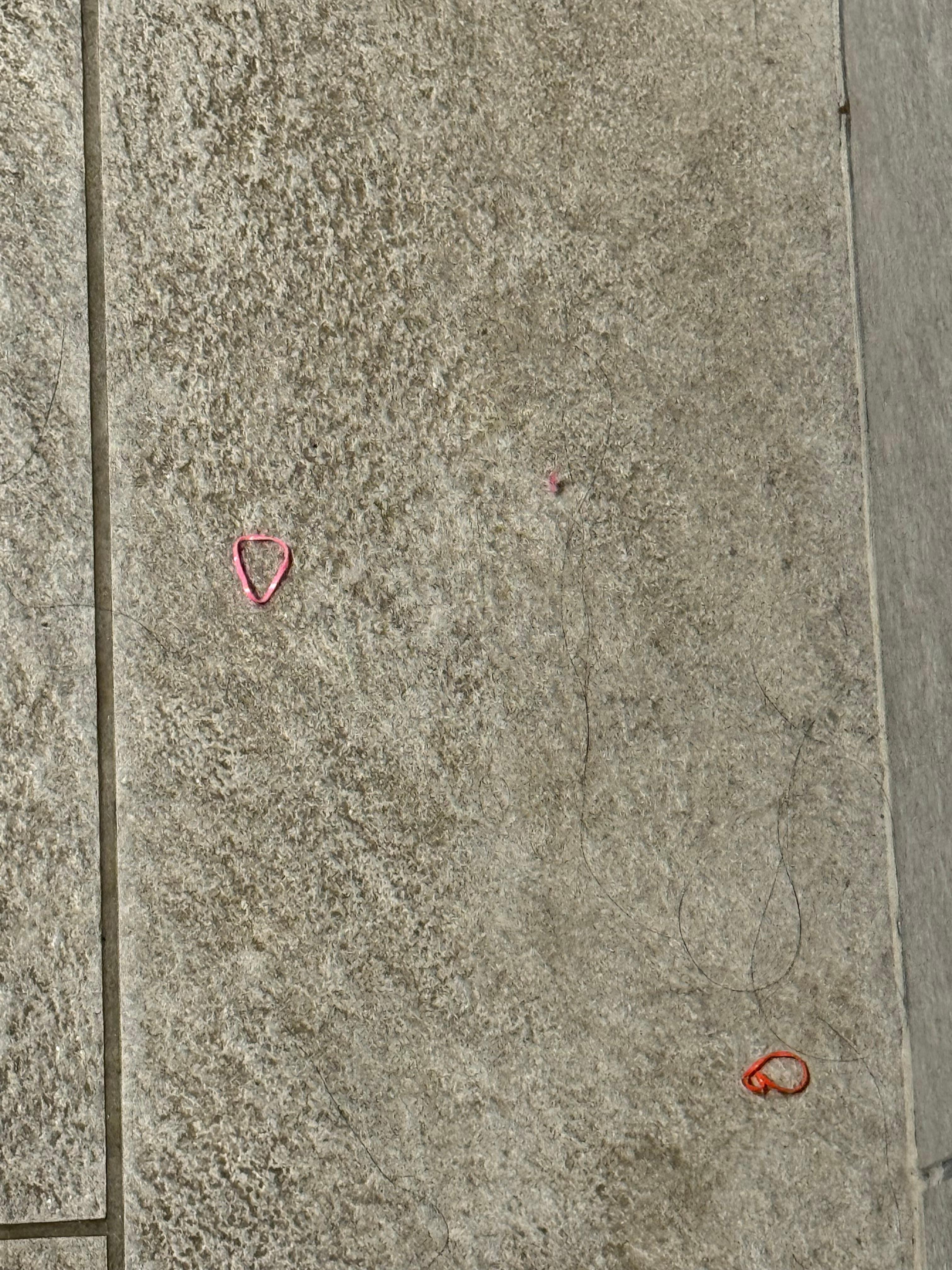 Hair ties all over the floor with hair