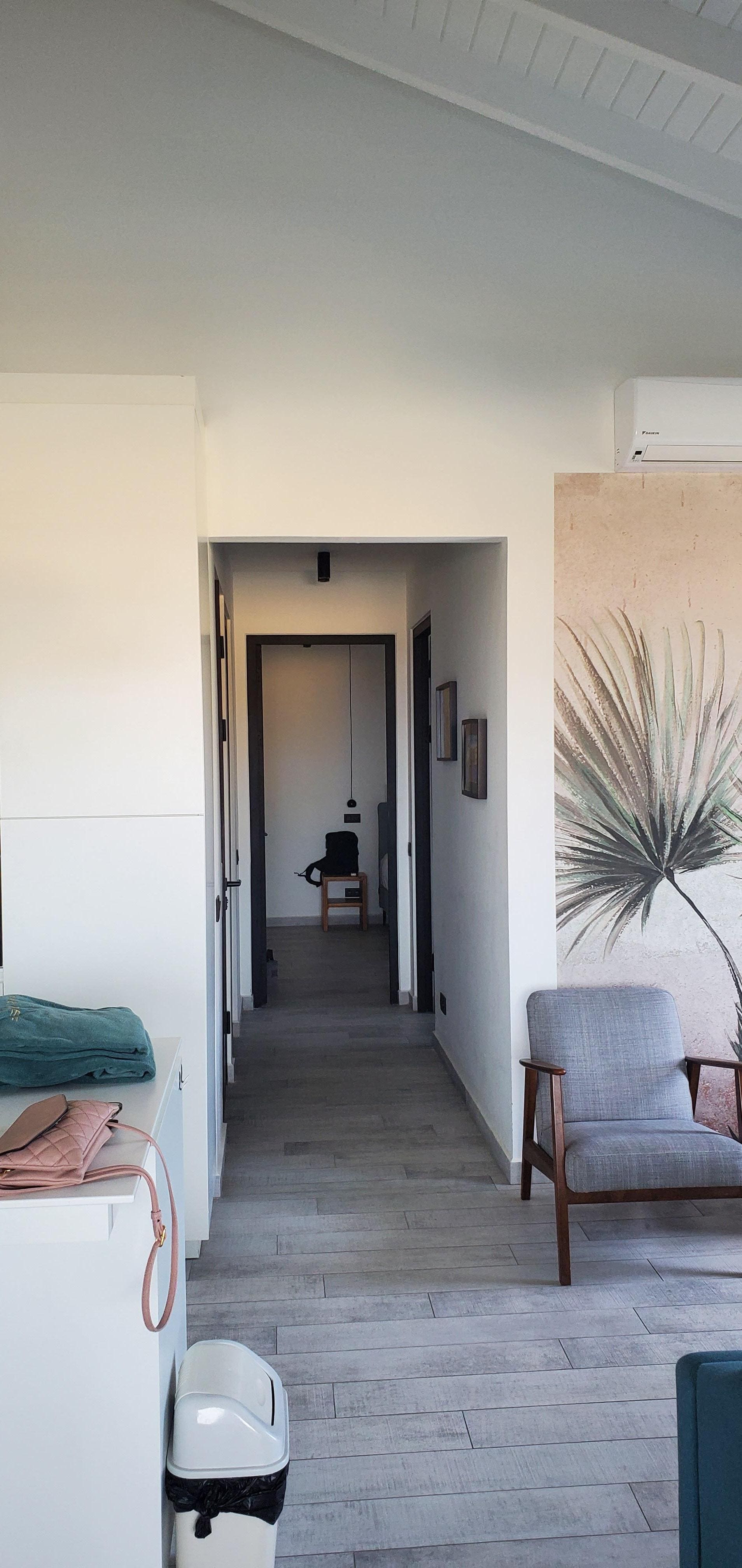 Looking from living area down to primary bedroom