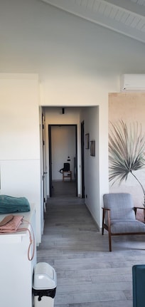 Looking from living area down to primary bedroom