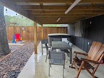 Downstairs Patio Table, Hot Tub, TV, Chairs