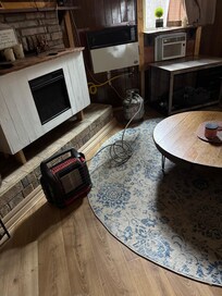 Extremely unsafe propane tank INSIDE a cabin by a heater that you could smell gas coming from