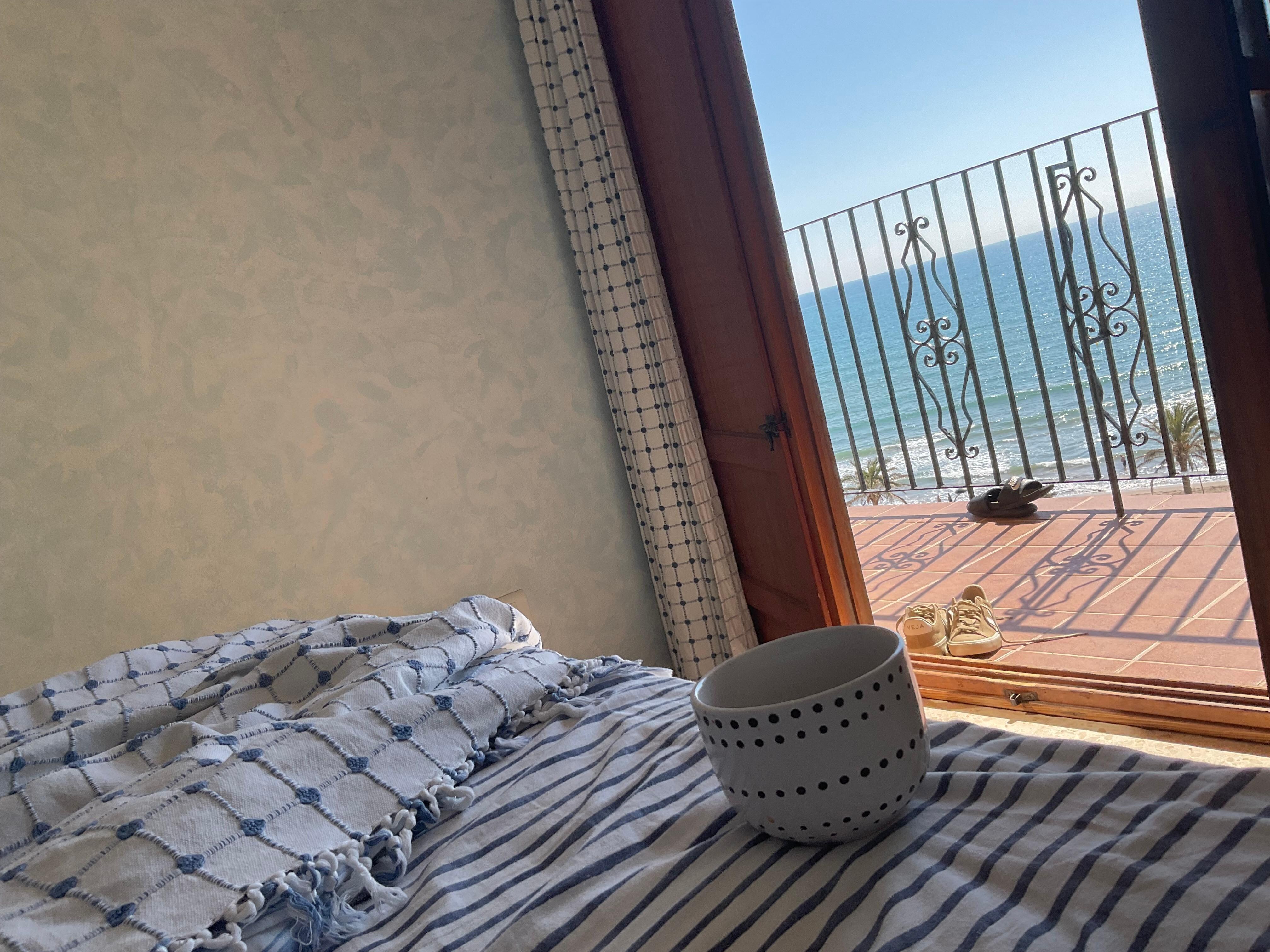 Bed with a view of the waves breaking on the beach accompanied with the wonderful relaxing sound - great way to go to sleep at night and wake up to the next morning