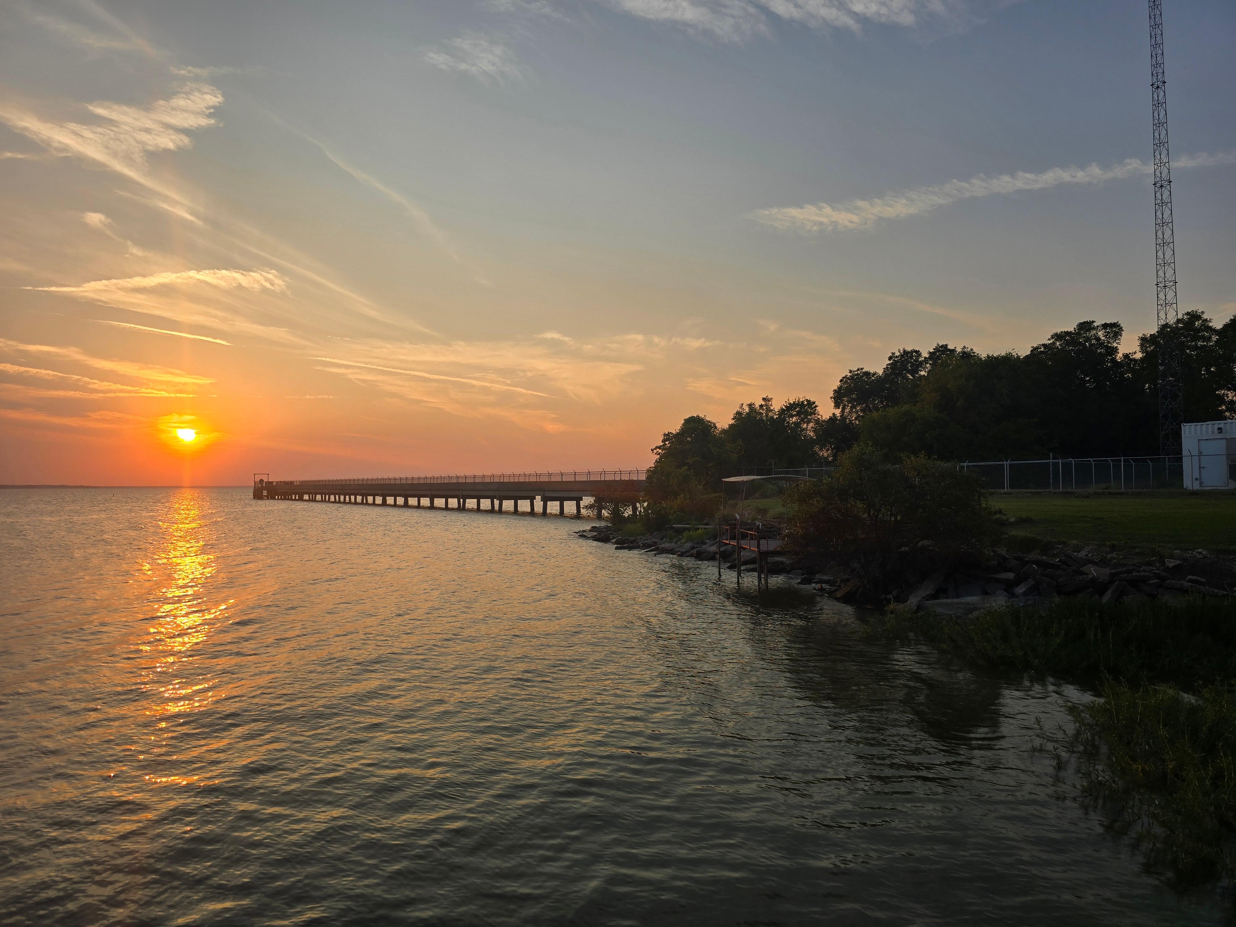 Sunset from the dock facing northwest showing the pier containing water pumps