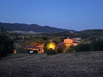 Picture of the house at night from the pool.