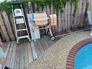 Cement mixer/ladder next to pool