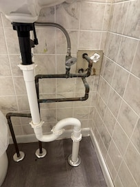 Toilet paper plugging a hole in the wall.