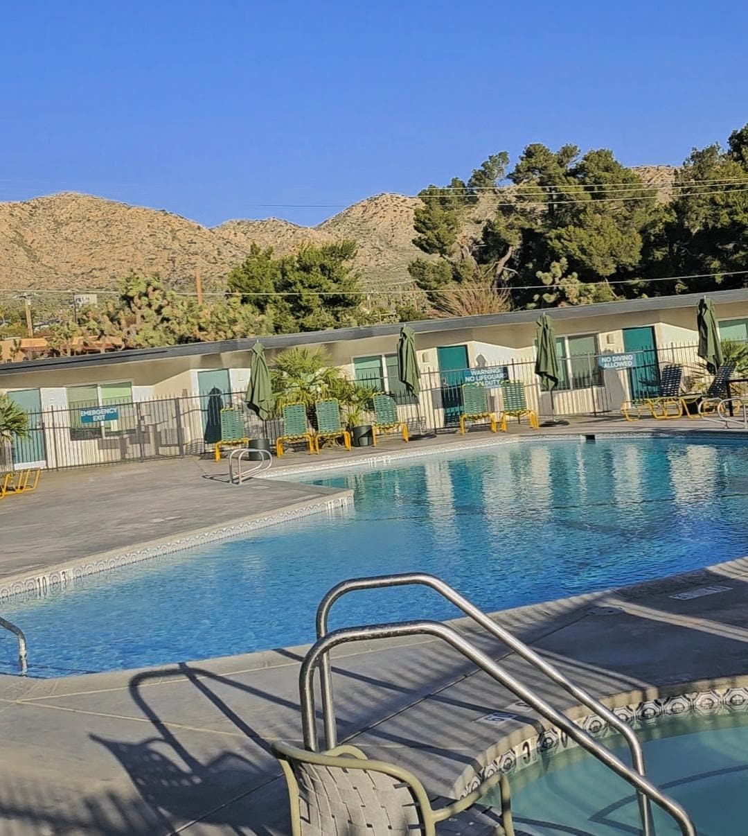 Pool and jacuzzi with mountains all around
