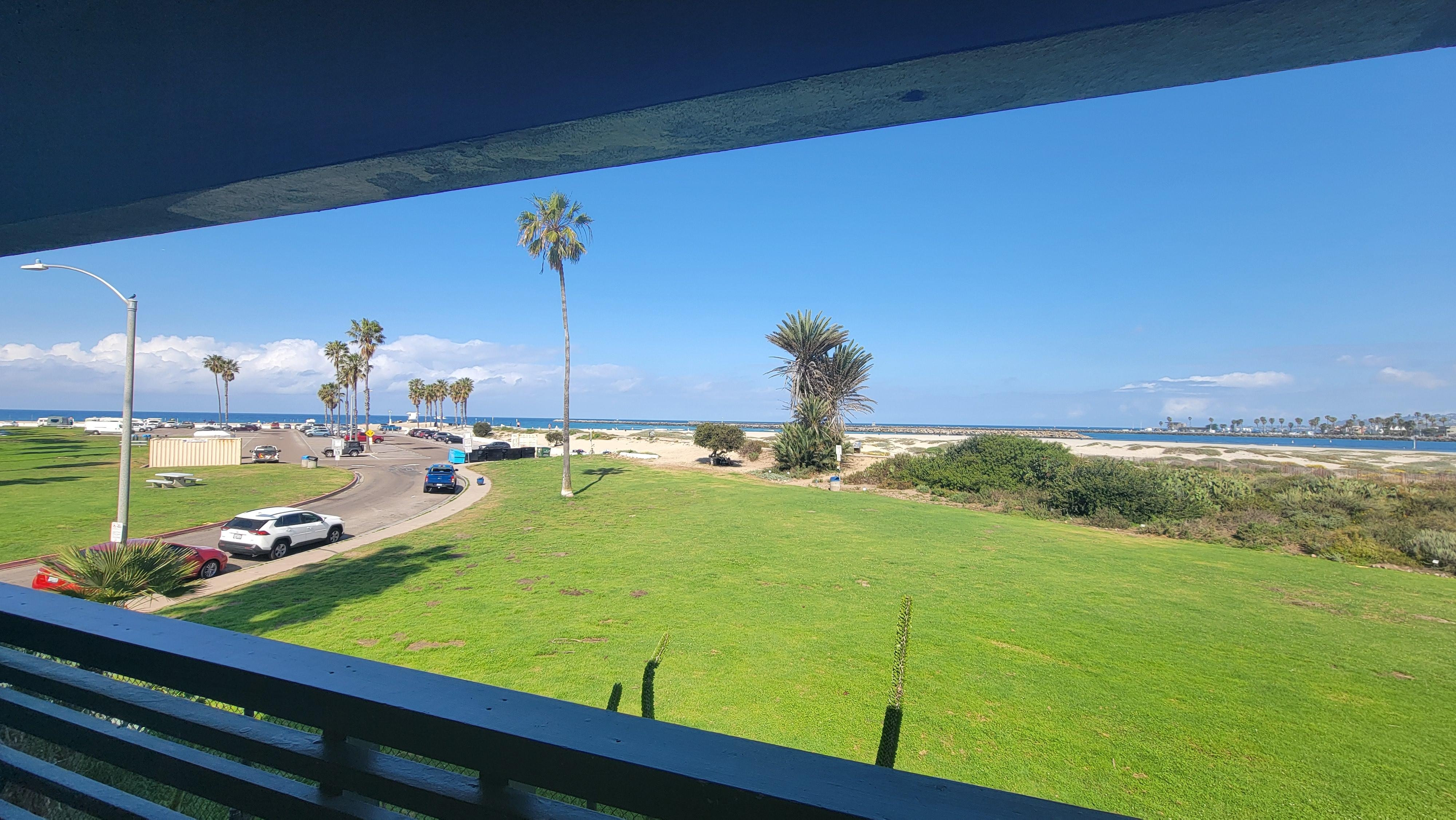 View from balcony that has a table and tall chairs. 