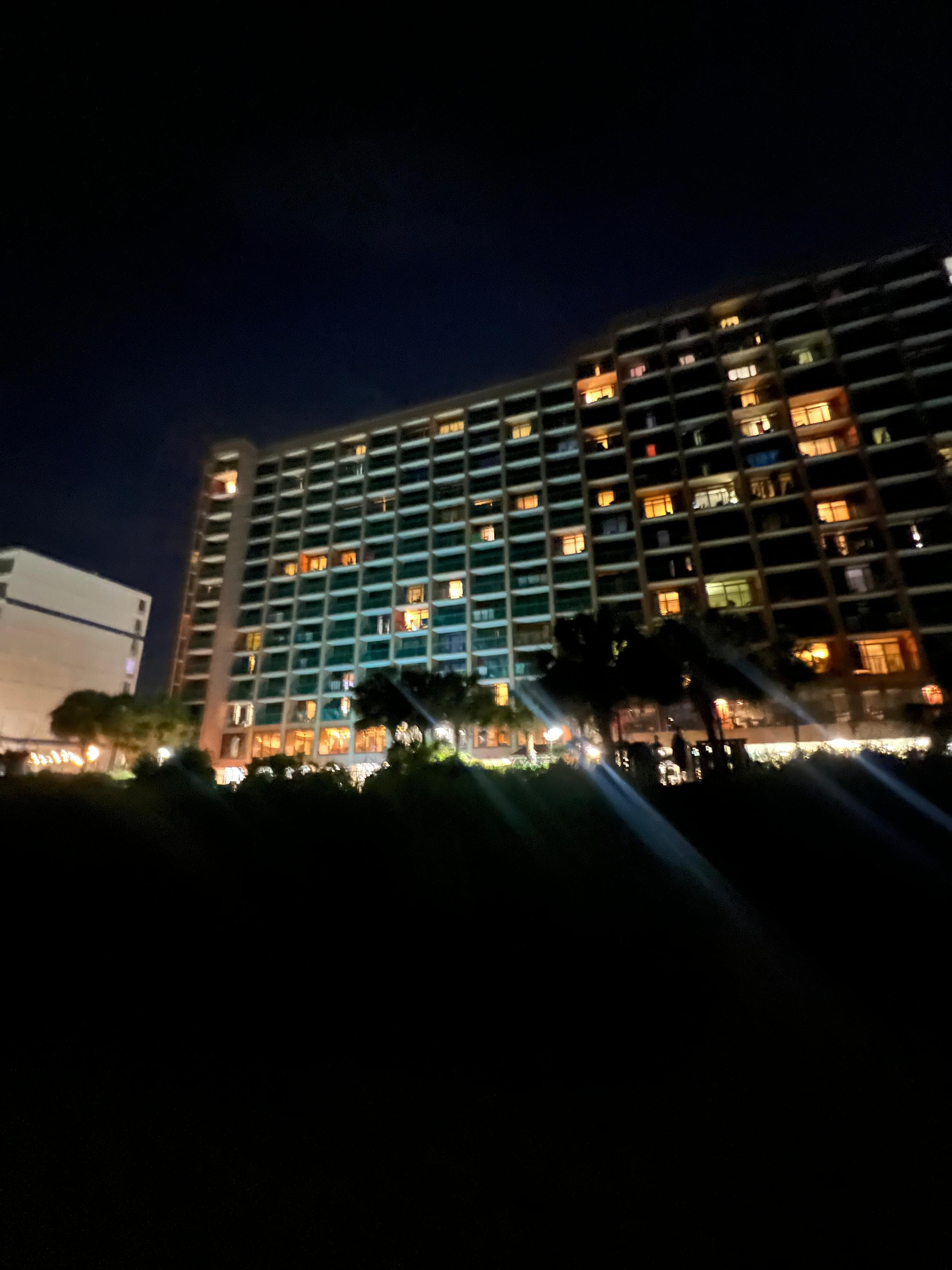 front of the hotel at night from the beach
