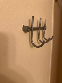 Towel rack holding on by one screw because the other was pulled out of the dry wall.