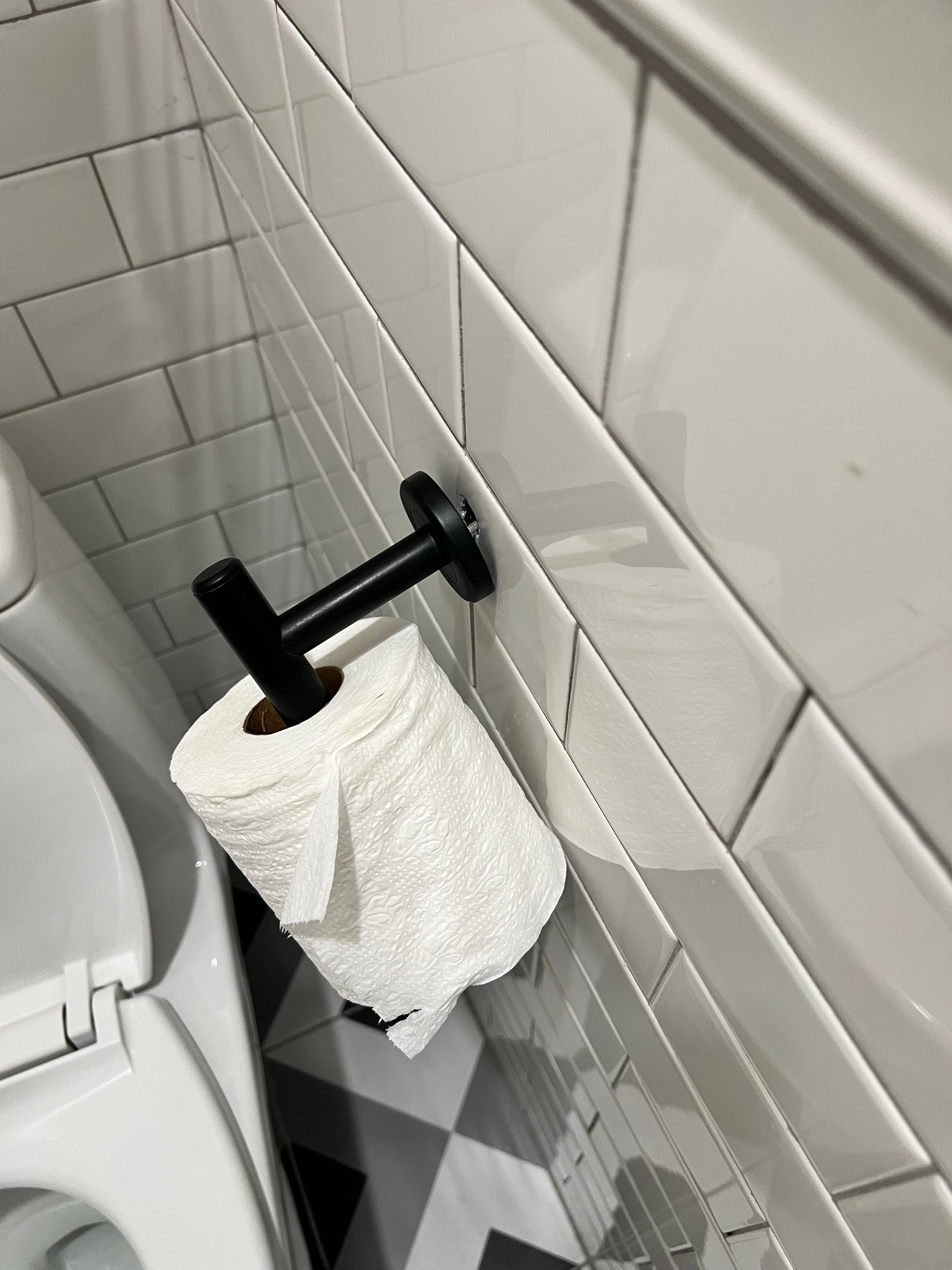 The bathroom was literally falling apart... this toilet paper holder was clinging by a screw.