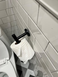 The bathroom was literally falling apart... this toilet paper holder was clinging by a screw.