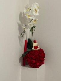 Flowers in corner of bedroom.