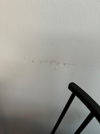 Damaged wall at kitchen bar