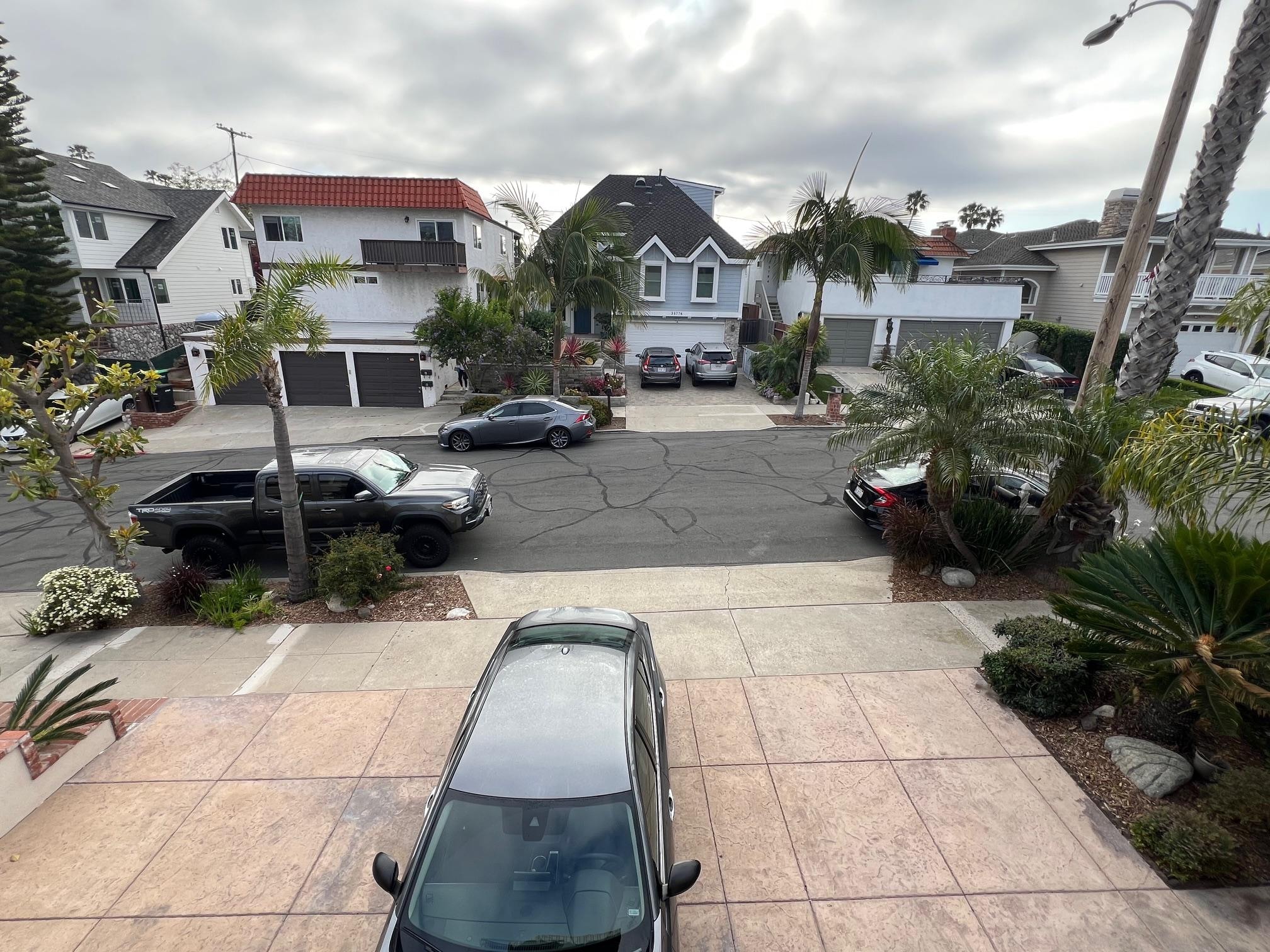 Cars parked on each side of driveway apron