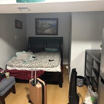 This is room 1 of the shared space. There is not a microwave in the room it is across the hall I. The kitchen. There is a refrigerator in the room.