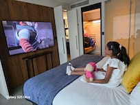 My daughter enjoying relaxing on bed and watching tv