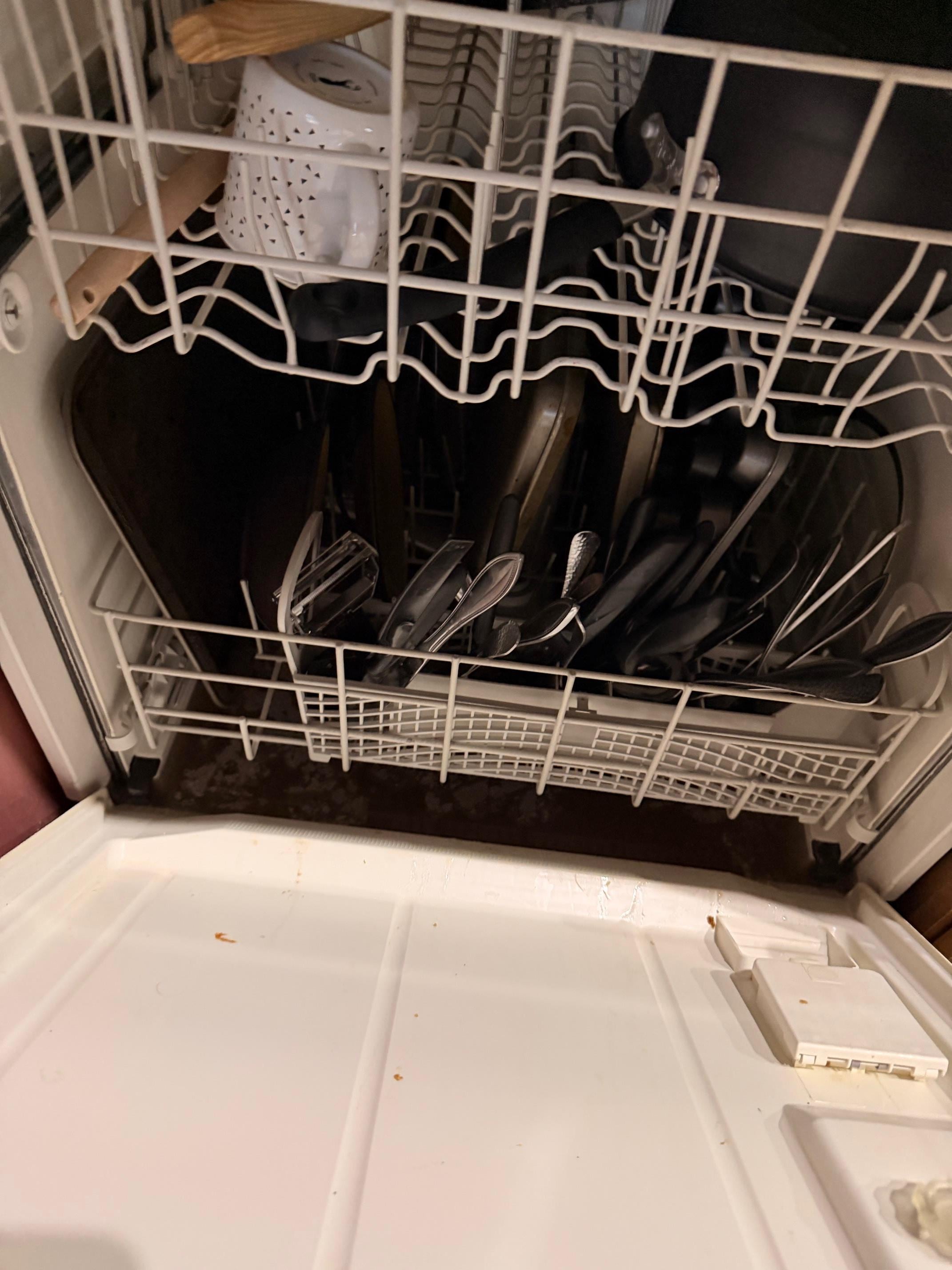 Previous renter's dirty dishes in a dishwasher we couldn't use.