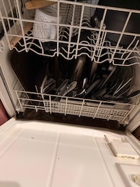 Previous renter's dirty dishes in a dishwasher we couldn't use.