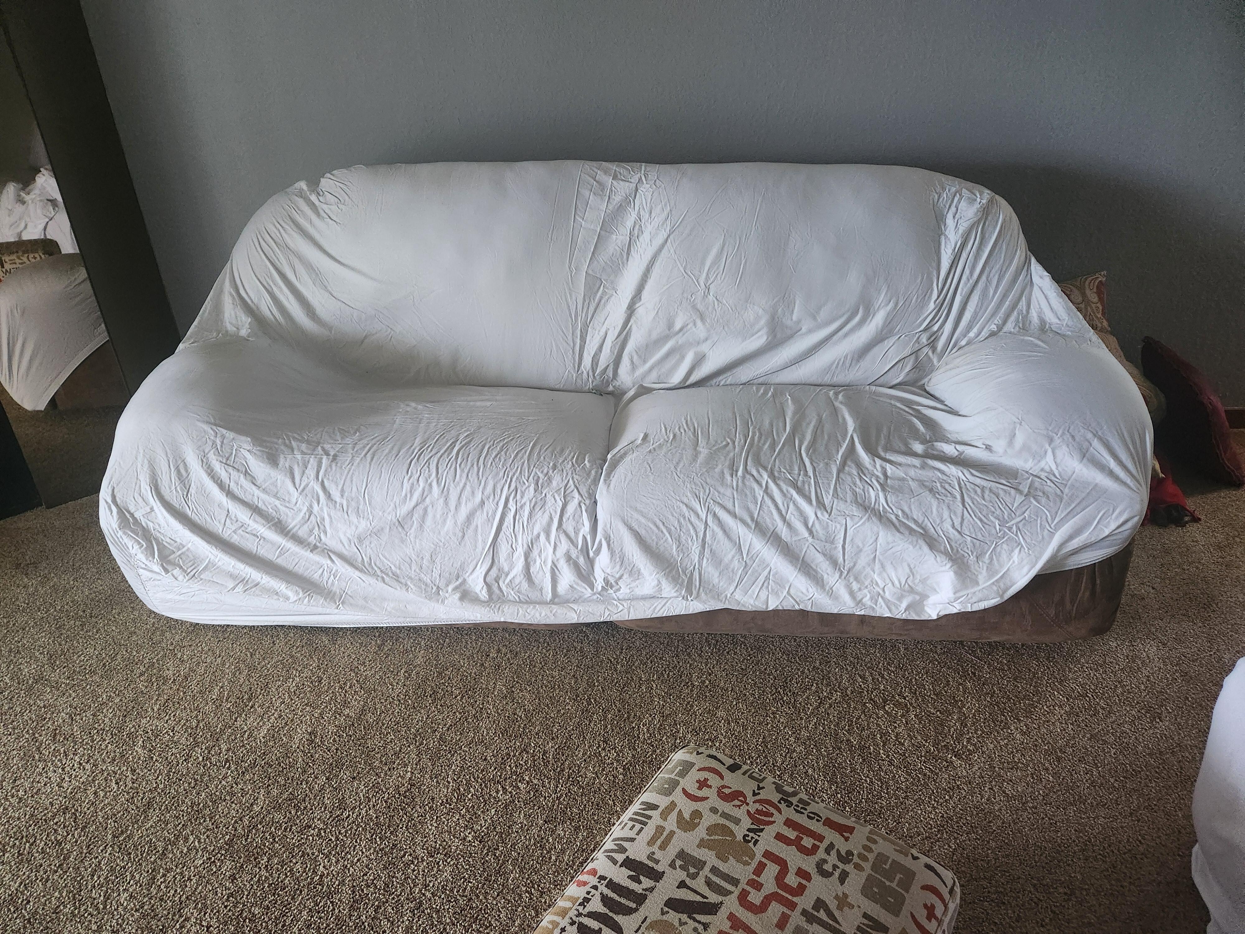 Couch dirty had to cover with a sheet