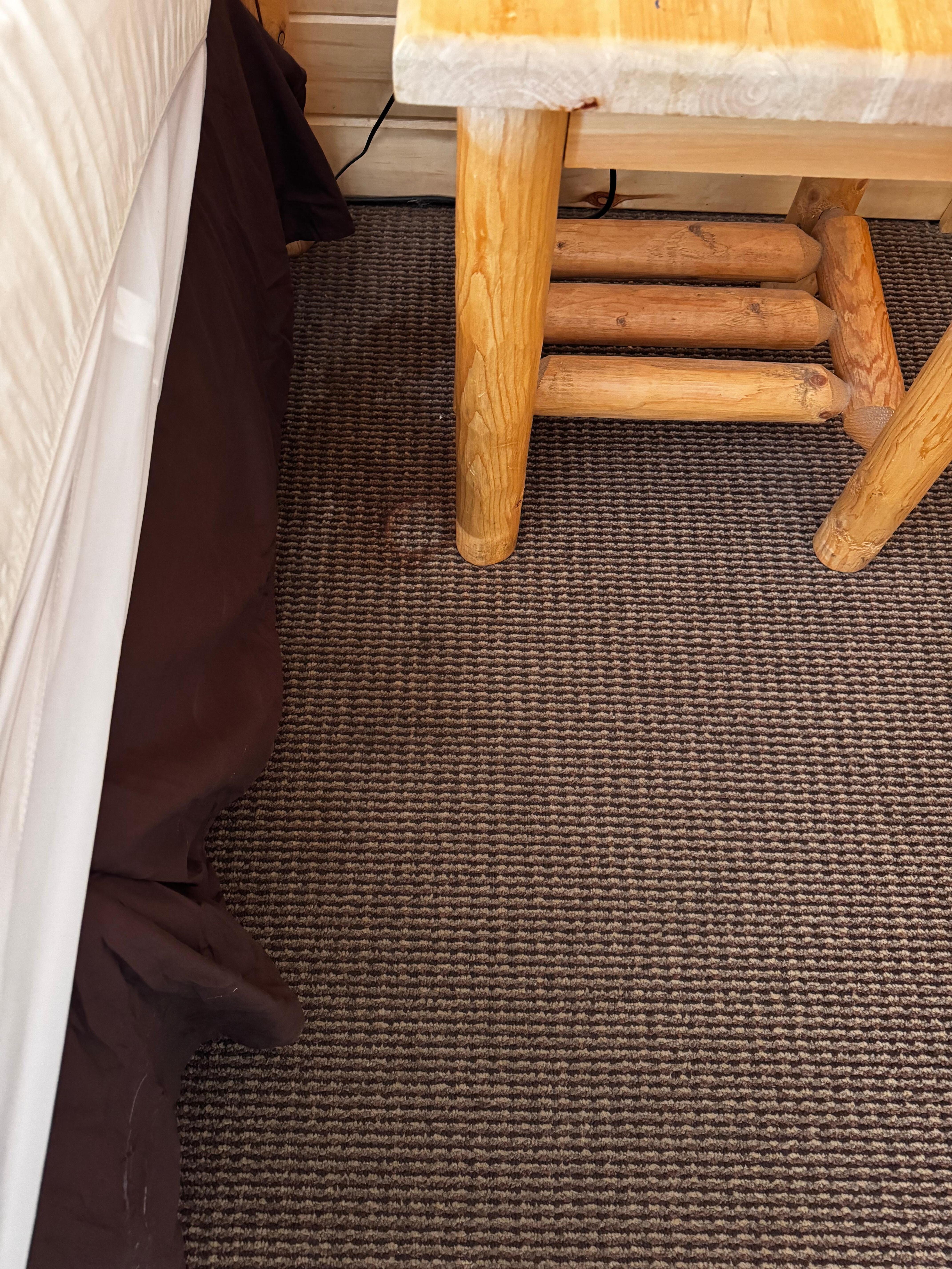 Carpet stain next to the bed 