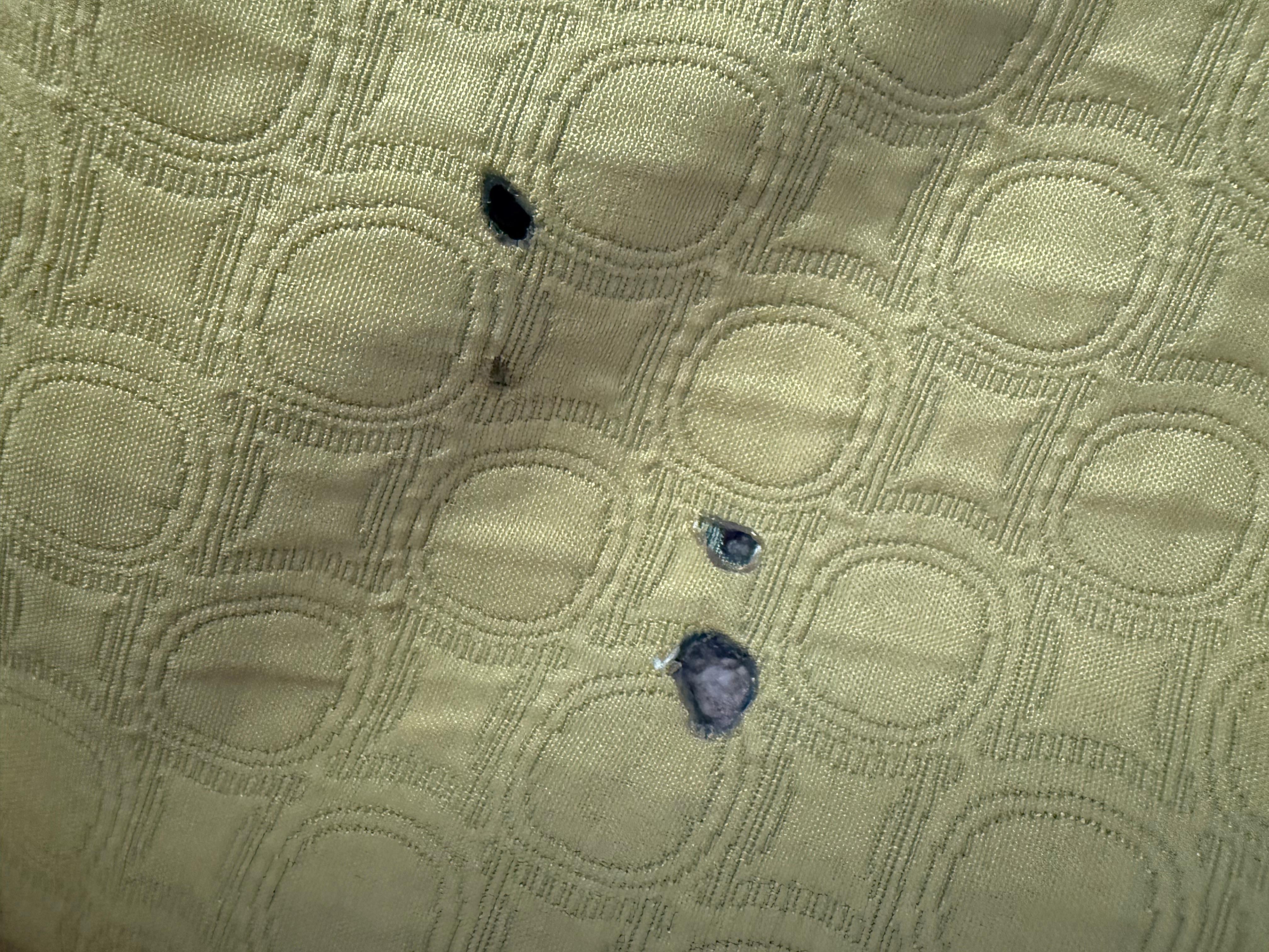 Burn holes in bed cover 