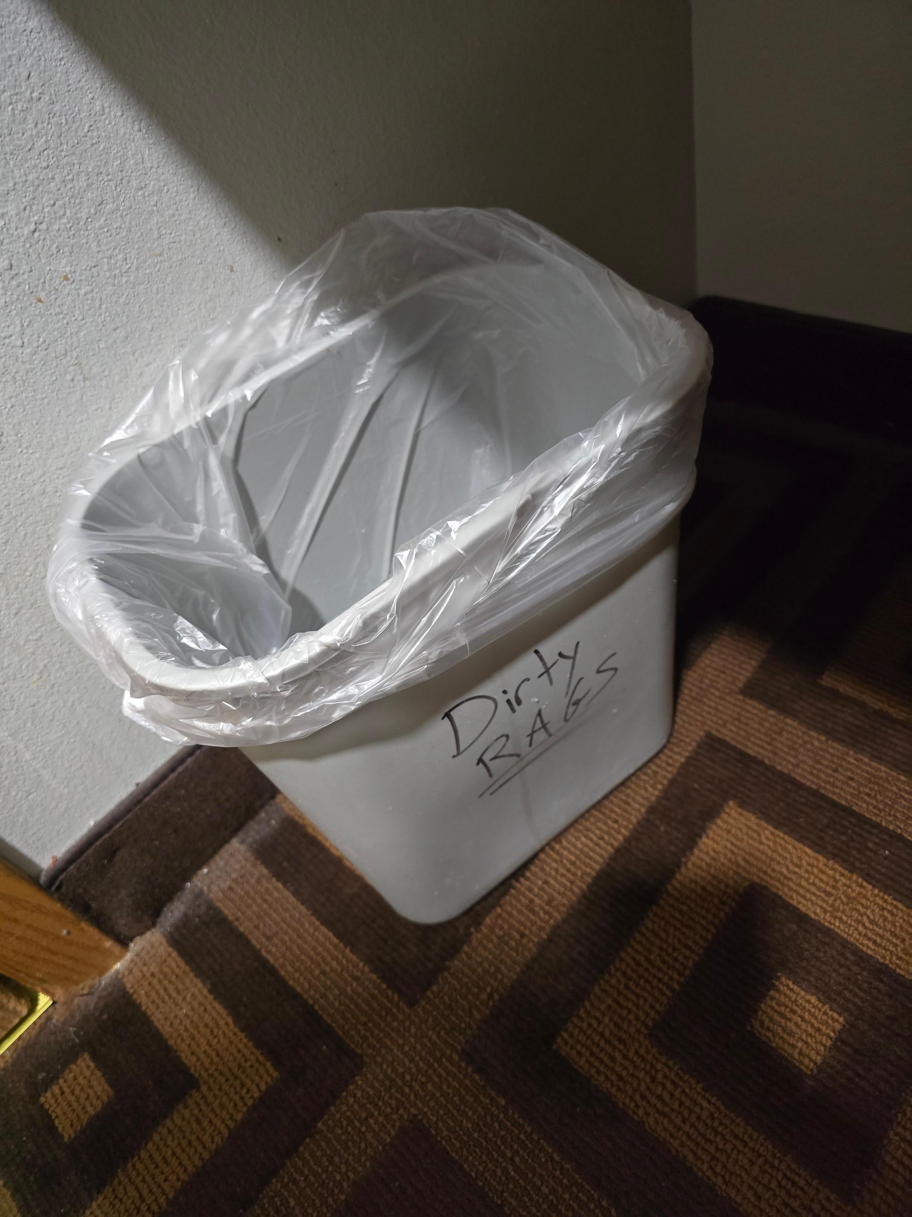 Garbage can for rags in room.