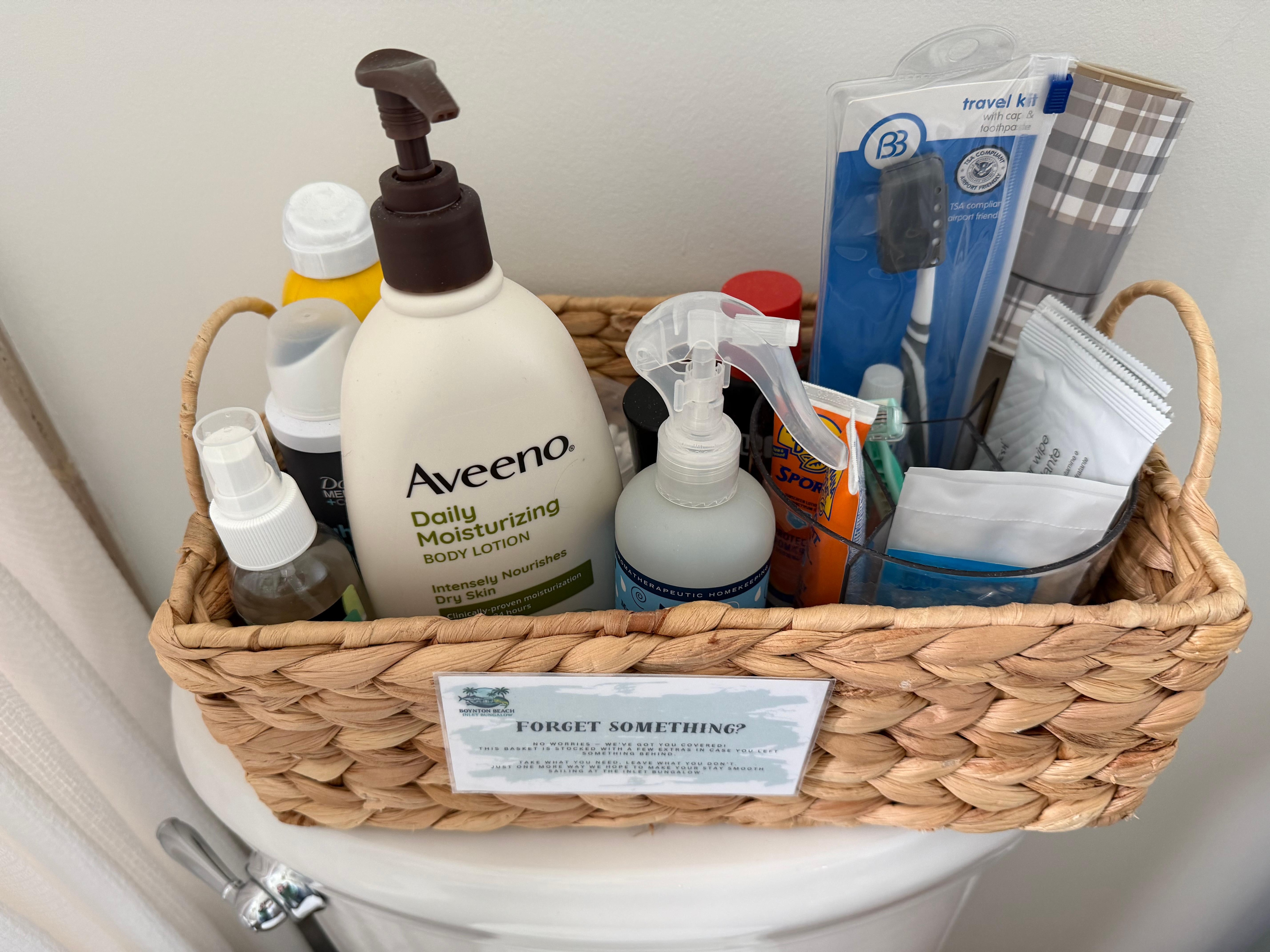 Basket in bathroom with items “you may have forgotten to pack” 